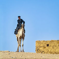 photo "Egyptian Tourist Police Officer Riding a Camel"