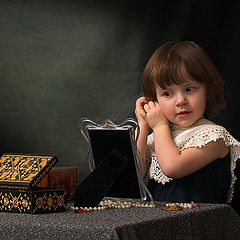 photo "a girl who is trying on earrings"