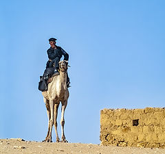 photo "Egyptian Tourist Police Officer Riding a Camel"